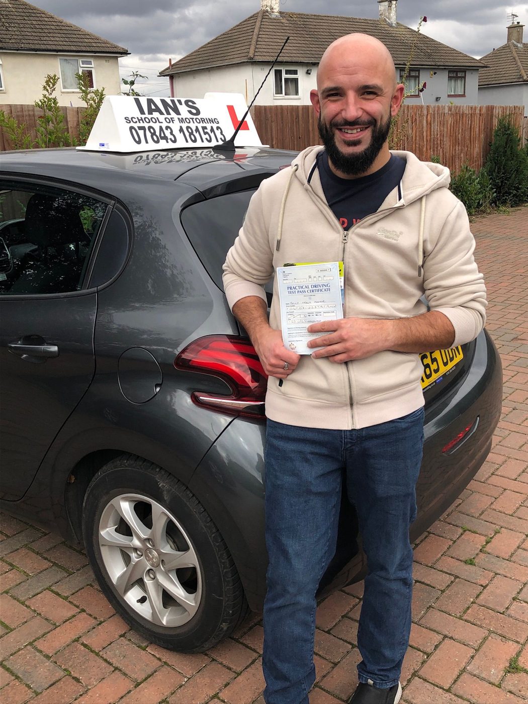 Driver celebrating passing his practical test with Ian's School of Motoring